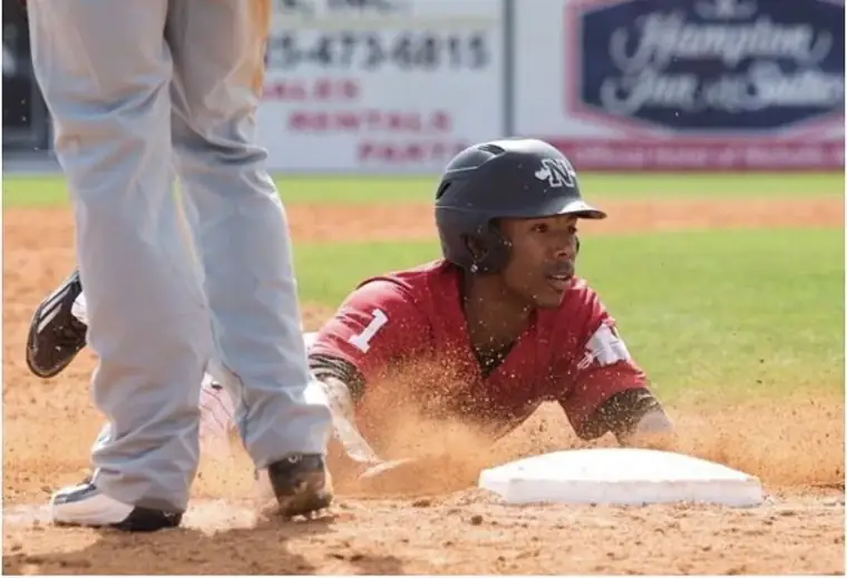Quade Smith sliding headfirst into the bag for Nicholls State